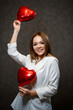 © DSMT - Beautiful girl in a white jacket with a red balloon heart in her hands