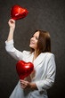 © DSMT - Beautiful girl in a white jacket with a red balloon heart in her hands