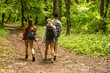 © BalanceFormCreative - Group of young people hiking trough forest.