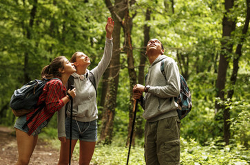 Wall Mural - portrait of young hikers in nature.they look around and joying in nature.
