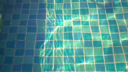 Wall Mural - Ripples on the water surface of the pool blue floor under the water nobody 