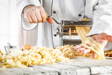 Sticker - Table background in kitchen with fresh pasta.Blurred spring window and sunny day. 