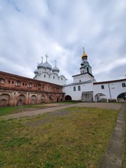 October 17, 2019 Russia, the city of Vologda. Depicted are two intersecting walls of brick and white, the St. Sophia Cathedral of the Wisdom of God, with domes in the background