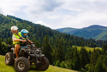 Happy Family Riding And Looking Quad Bike On Mountain. Cute Boy On Quadricycle. Family Summer Vacation Activity.