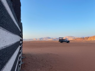 Wall Mural - car on the Wadi Rum desert in Jordan