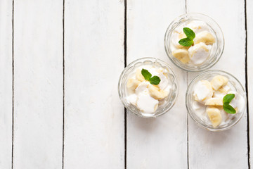 Wall Mural - Banana with sour cream on white background