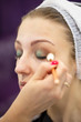 © alexlukin - Portrait of a young girl and makeup artist hand applying makeup with cosmetic brush