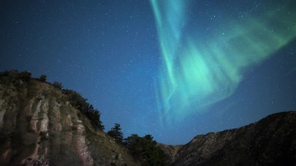 aurora borealis milky way above alpine mountain cliff time lapse simulated northern lights
