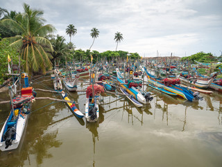 Wall Mural - Image of lots of traditional wooden fishing boats in the ocean harbor at Sri Lanka