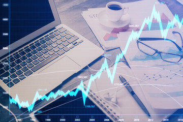 Financial market graph hologram and personal computer on background. Multi exposure. Concept of forex.