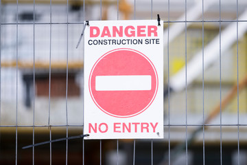 Construction danger no entry sign on entrance fence