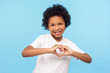 © khosrork - Portrait of smiling cheerful little boy with curly hair in white T-shirt showing heart shape with fingers, expressing innocent childhood love, affection. indoor studio shot isolated on blue background