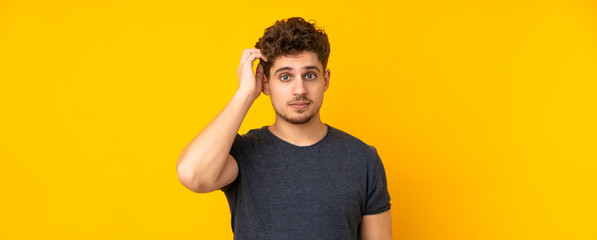 Young caucasian man isolated background with an expression of frustration and not understanding