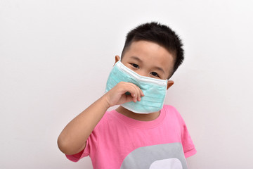 Asian little boy wearing the mask on white background.