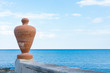 Big orange flower pot on the boulevard along the Adriatic Sea. Trani, Italy