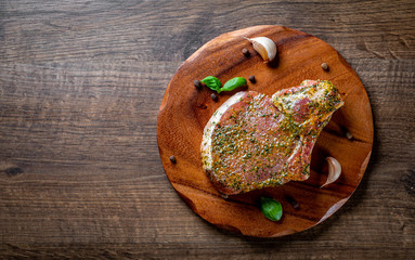 Wall Mural - Raw Pork Loin chops marinated meat Steak for bbq on wooden table background