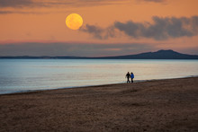 Silhouette Of Couple On The Beach Under Supermoon