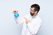 © luismolinero - Young scientific holding laboratory flask over isolated background