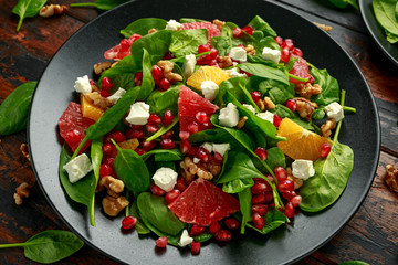 Wall Mural - Orange Grapefruit salad with spinach, walnuts, pomegranate seeds and feta cheese. healthy food