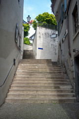  The stone stair in midtown Zurich alley on blue sky background , copy space , Switzerland