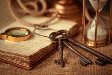 Old Vintage Items Of The Treasure Hunter, Traveler And Discoverer - A Magnifying Glass, Old Manuscripts, A Globe, Keys To Chests. The Concept Of Luck, Unexpected Wealth, Luck And Romance.