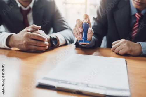 Cuadros en Lienzo Businessman stamping with approved stamp on document contract.