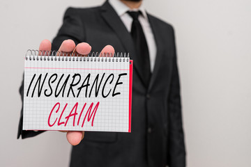 Text sign showing Insurance Claim. Business photo text coverage or compensation for a covered loss or policy event Male human wear formal work suit office look hold mathematics book use hand