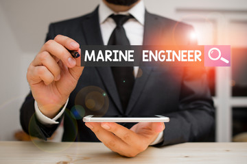 Conceptual hand writing showing Marine Engineer. Concept meaning incharge with maintenance and operation of a ship s is engines Male human wear formal clothes present use hitech smartphone