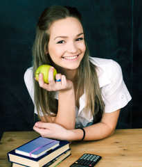 portrait of happy cute student with book in classroom