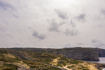 Aerial drone view of rocky coastline and sea. Blue hole and the collapsed Azure window in Dwejra Bay, Gozo, Malta