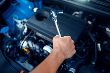 Wall Mural - Worker disassembles vehicle engine, car service