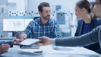 Poster - Modern Factory Office Meeting Room: Multi-Ethnic and Diverse Team of Engineers, Managers and Investors Talking Sitting at Conference Table, Analyzing Blueprints, Showing Information on Laptop Computer