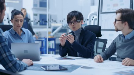 Aufkleber - Factory Office Meeting Room: Computer Design Specialist Holds Printed Circuit Board Prototype and Reports to Diverse Team of Engineers, Managers Sitting at Conference Table. Industrial Facility