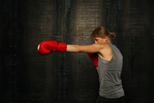 Portrait Of Athletic Woman In Red Boxing Gloves