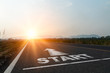 © Yingyaipumi - Concept of start straight and beginning for cooperation.Start text on the highway road concept for planning and challenge or career path,business strategy,opportunity and change in sunset background.