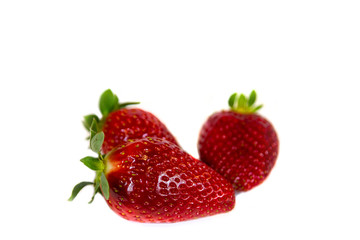 Red Strawberries. Close Up shot of fresh strawberries. Strawberry Fruit Food. Fresh, red and tasty strawberries isolated on a white background. 