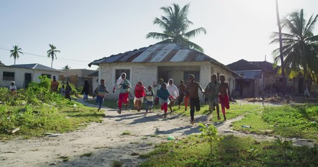 authentic shot of happy carefree rural african kids friends are having fun to run and laughing in a 