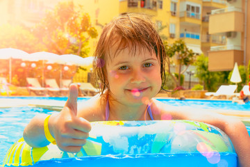 Cute little child girl having fun in water. Summer vacation and happy life concept