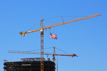 American Flag, Proudly Flying Over A Building Under Construction