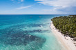 Tropical island background: paradise blue water and white sand beach at exotic island. Aerial drone view