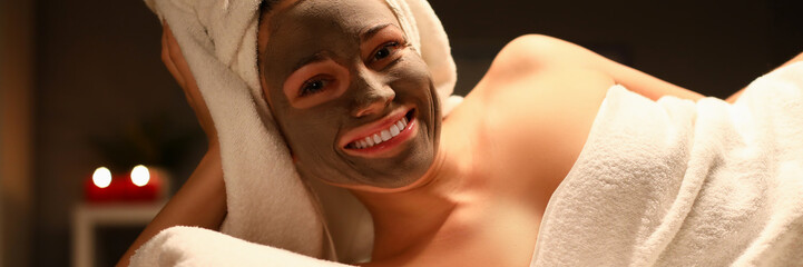 Wall Mural - Beaty woman applied chocolate mask in spa salon facial portrait. Heath skin care concept. Look at camera person