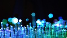 Abstract Composite Image Of Over Multiple Defocused Blurred View Of Large Fiber Optics Light With Red Background - 4k UHD Footage For Intro Of Technology Concept