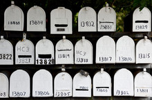 Several Rows Of White Metal Numbered United States Post Office Mailboxes