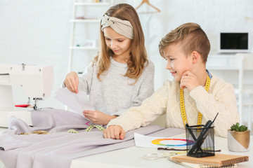 Canvas Print - Cute little tailors working in atelier