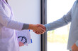 © ntinai - The doctor shook hands with someone who came to heal the illness..Show that pleased with strong health.