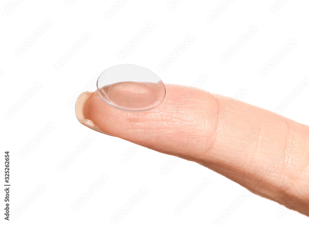 Finger with contact lens on white background