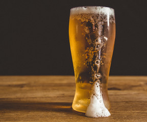 glass of beer with foam on white background