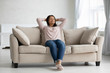 © fizkes - Calm african American woman relax daydream on cozy couch