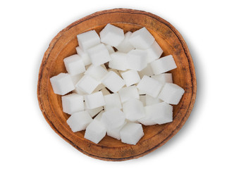 Wall Mural - Wooden bowl of natural white sugar cubes on white background.