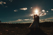 Silhouette of the bride and groom against the sky at sunset. newlyweds stand against the sky